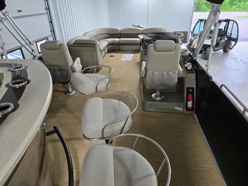Slide: The Image of 2013 Premier 290 Grand Entertainer pontoon boat interior with seating and helm. - 24