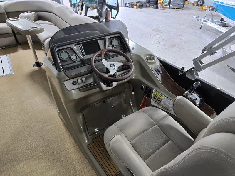Slide: The Image of 2013 Premier 290 Grand Entertainer boat interior with steering console and seating. - 25