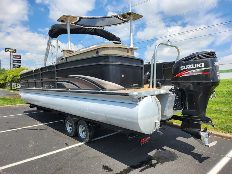 Slide: The Image of 2013 Premier 290 Grand Entertainer pontoon boat with Suzuki 300 outboard motor in parking lot. - 4