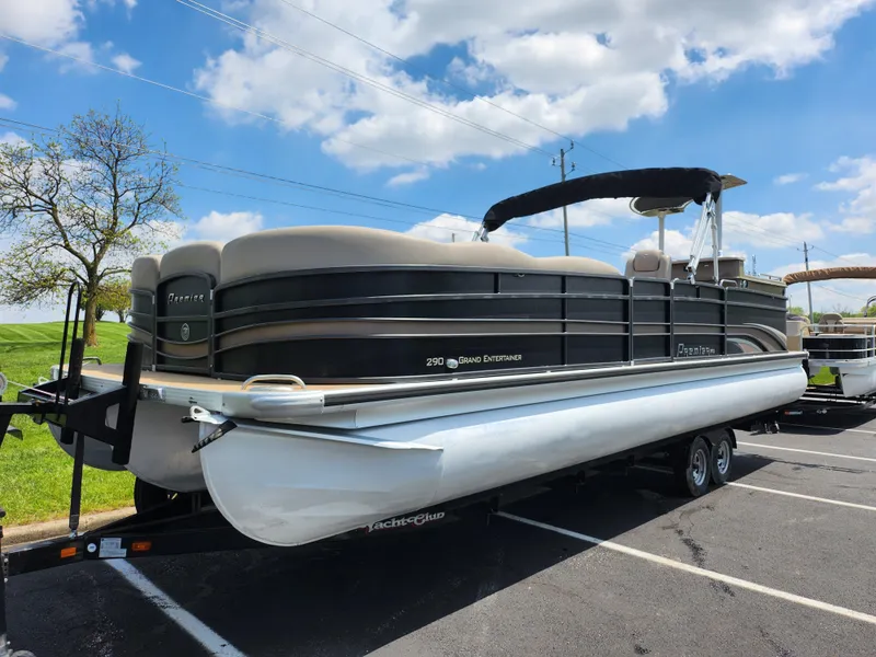 Slide: The Image of 2013 Premier 290 Grand Entertainer pontoon boat on trailer under blue sky. - 6