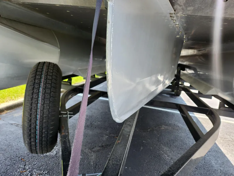 Slide: The Image of 2013 Premier 290 Grand Entertainer boat underside with trailer and tire visible. - 8