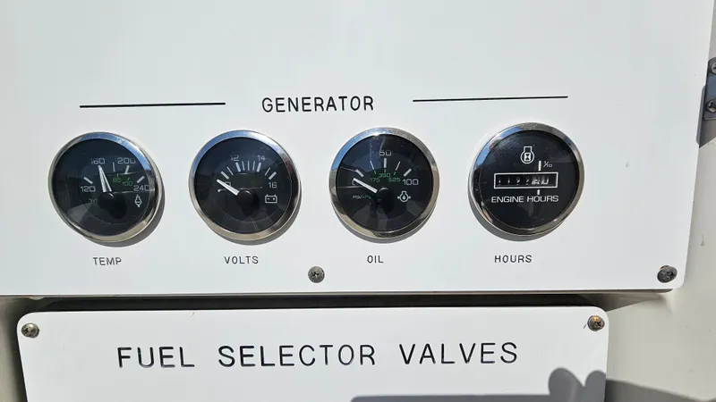 Slide: The Image of Control panel of a 2003 Sea Ray 410 Express Cruiser with gauges and fuel selector valves. - 20