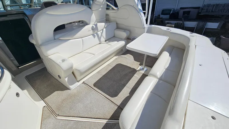 Slide: The Image of 2003 Sea Ray 410 Express Cruiser interior with white seating and table. - 21