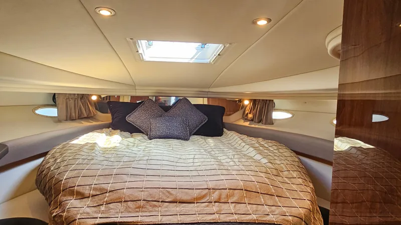 Slide: The Image of Luxurious cabin interior of 2003 Sea Ray 410 Express Cruiser with cozy bedding. - 39