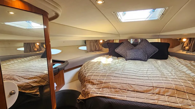Slide: The Image of Luxurious cabin interior of 2003 Sea Ray 410 Express Cruiser with cozy bedding and skylight. - 40