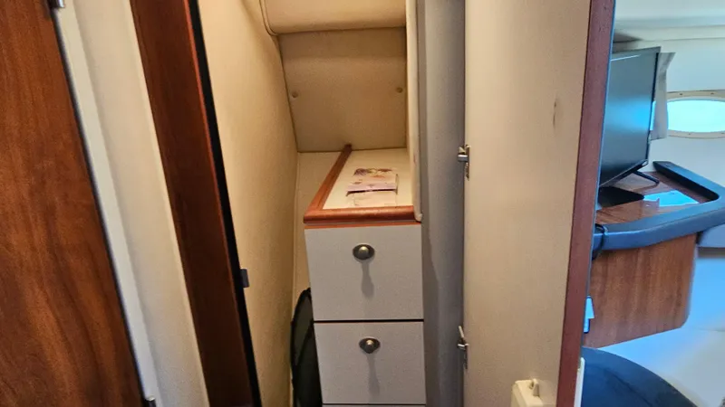 Slide: The Image of Interior of 2003 Sea Ray 410 Express Cruiser with storage drawers and modern furnishings. - 43