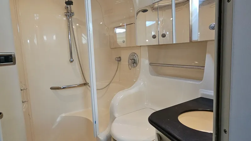 Slide: The Image of Bathroom interior of 2003 Sea Ray 410 Express Cruiser, featuring shower and sink. - 45