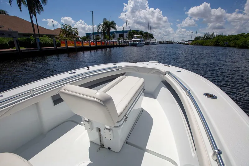 Slide: The Image of 2022 Yellowfin 26 Hybrid boat on a sunny day, docked by a canal. - 6