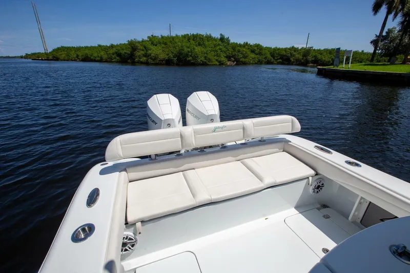 Slide: The Image of 2022 Yellowfin 26 Hybrid boat with dual engines on a calm waterway. - 9