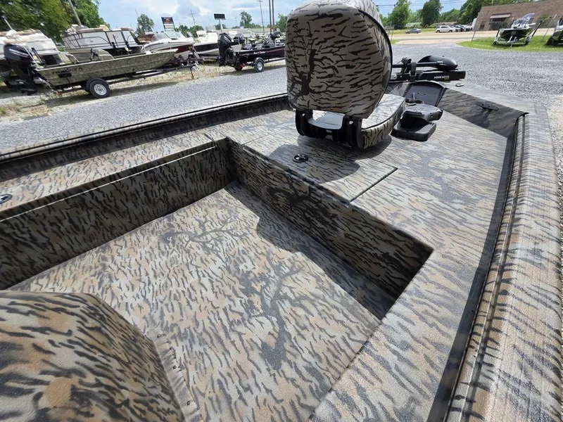 Slide: The Image of 2025 Xpress XP180 boat with camouflage interior, parked outdoors. - 10
