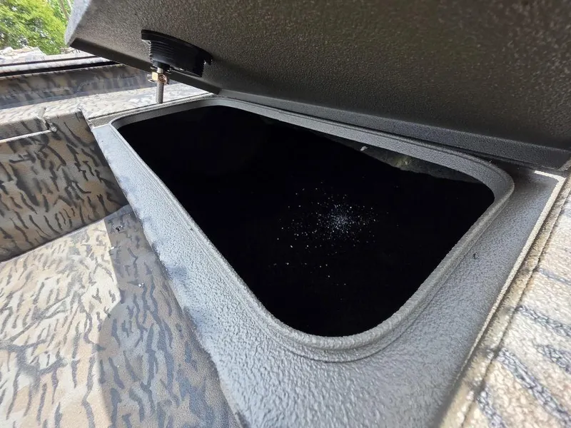 Slide: The Image of Open storage compartment on 2025 Xpress XP180 boat, showcasing interior space. - 11