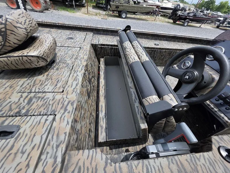 Slide: The Image of 2025 Xpress XP180 boat interior with camouflage design and steering wheel. - 13