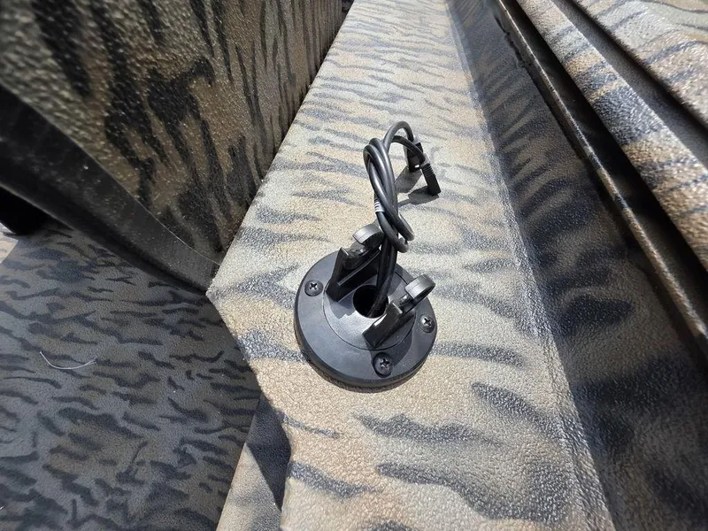 Slide: The Image of Close-up of a 2025 Xpress XP180 boat's camo-patterned deck with a mounted accessory holder. - 14
