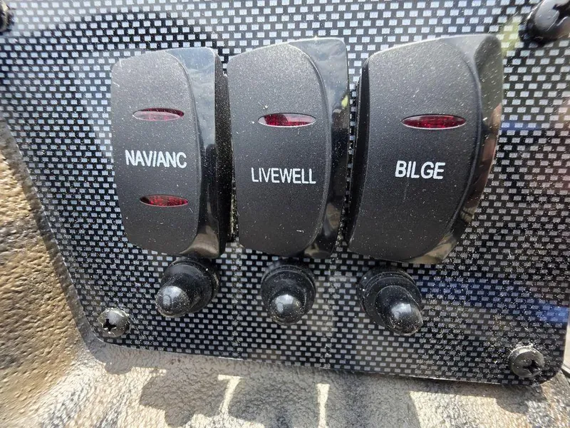Slide: The Image of Control panel of 2025 Xpress XP180 boat with switches for Navianc, Livewell, and Bilge. - 18