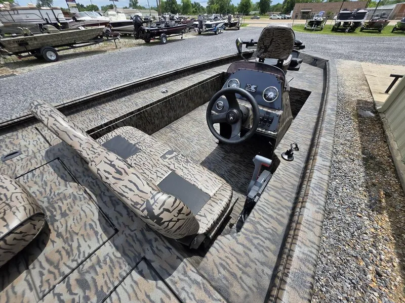 Slide: The Image of 2025 Xpress XP180 boat interior with camouflage seats and steering console. - 20