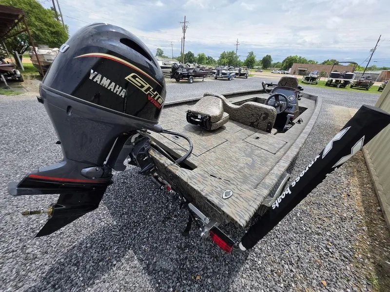 Slide: The Image of 2025 Xpress XP180 boat with Yamaha engine, parked on gravel lot. - 21