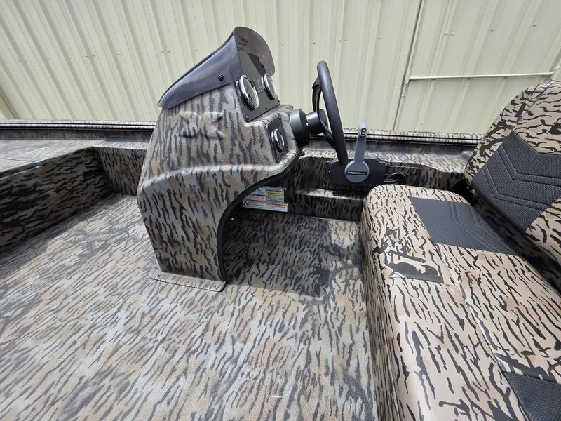 Slide: The Image of 2025 Xpress XP180 boat interior with camouflage design and steering console. - 5