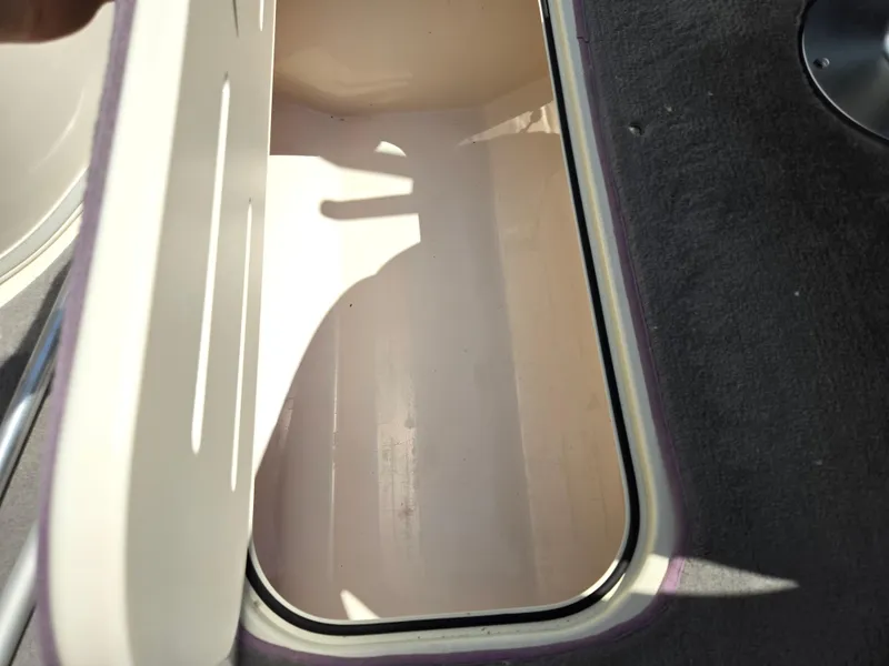 Slide: The Image of Open storage compartment in a 2013 Bryant 210 STE boat. - 12