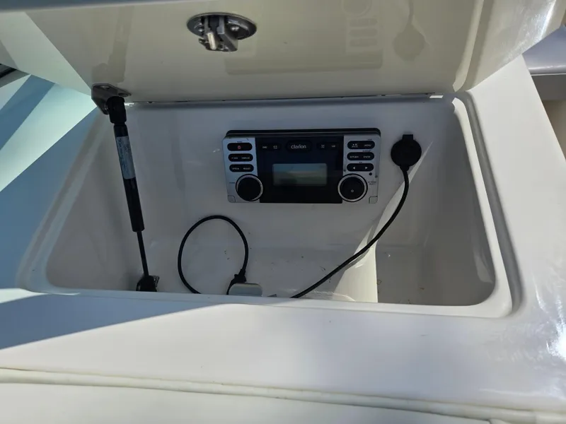 Slide: The Image of 2013 Bryant 210 STE boat stereo system in storage compartment. - 14