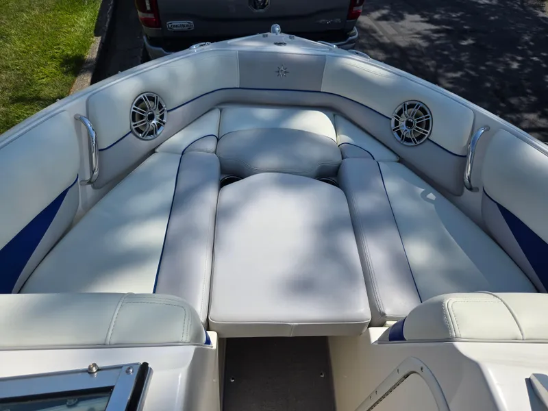 Slide: The Image of Luxurious seating area on a 2013 Bryant 210 STE boat with built-in speakers. - 16