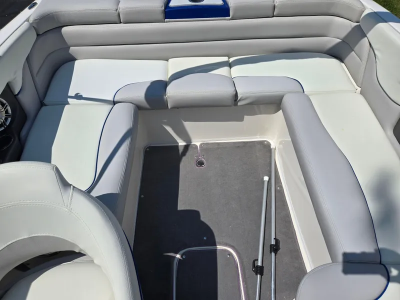 Slide: The Image of Interior of a 2013 Bryant 210 STE boat with gray and white seating. - 21