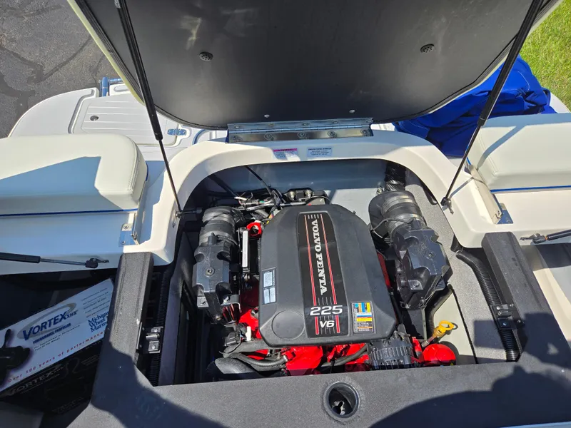 Slide: The Image of Open engine compartment of a 2013 Bryant 210 STE boat, featuring a Volvo Penta 225 V6 engine. - 23