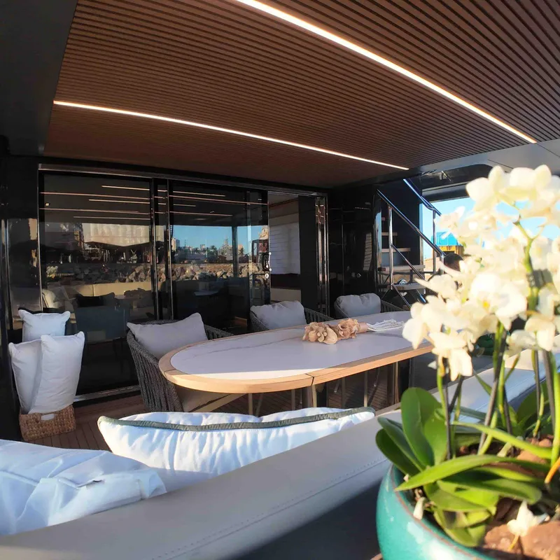 Slide: The Image of Luxurious Inace AVENTURA 106 yacht interior, featuring elegant seating and floral decor, 2027 model. - 11