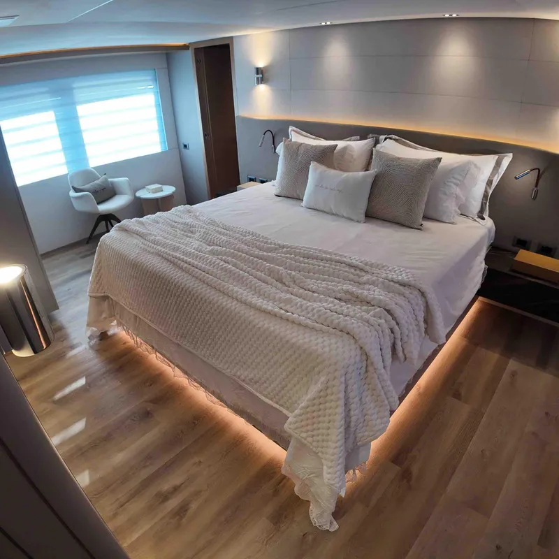Slide: The Image of Luxurious bedroom interior on Inace AVENTURA 106 yacht, 2027 model, featuring elegant lighting and modern design. - 12