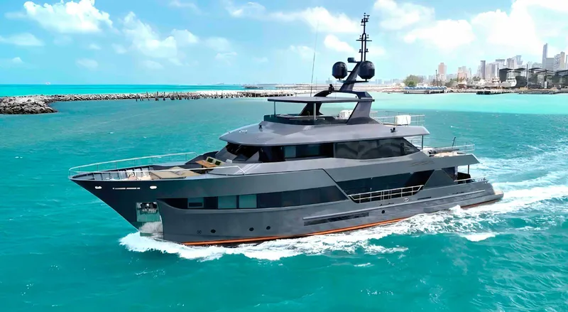 Slide: The Image of Luxurious 2027 Inace AVENTURA 106 yacht cruising in turquoise waters near a cityscape. - 16