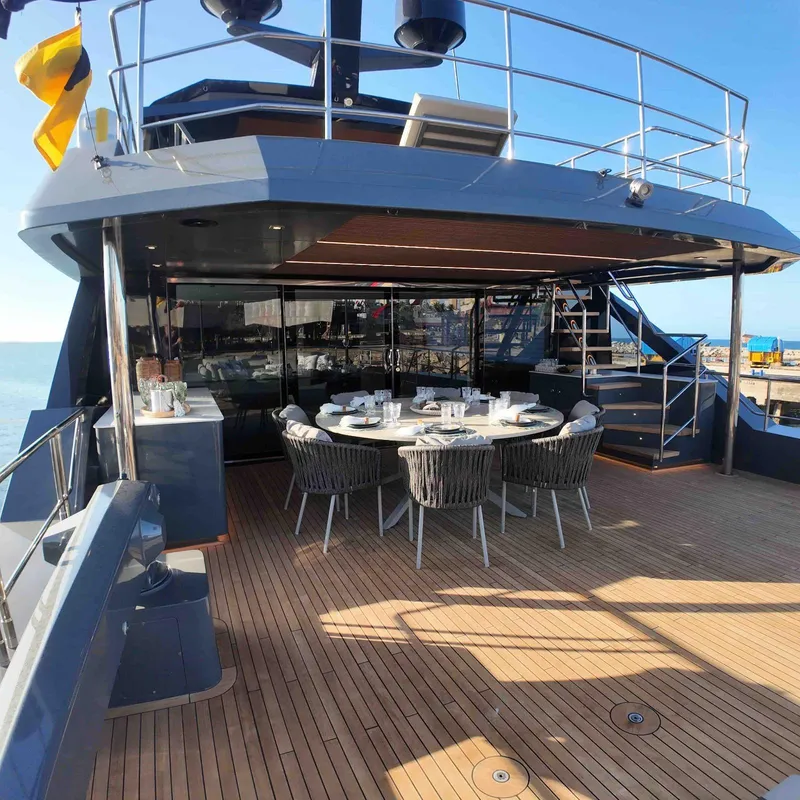 Slide: The Image of Luxury yacht Inace AVENTURA 106, 2027 model, featuring elegant outdoor dining area on deck. - 2