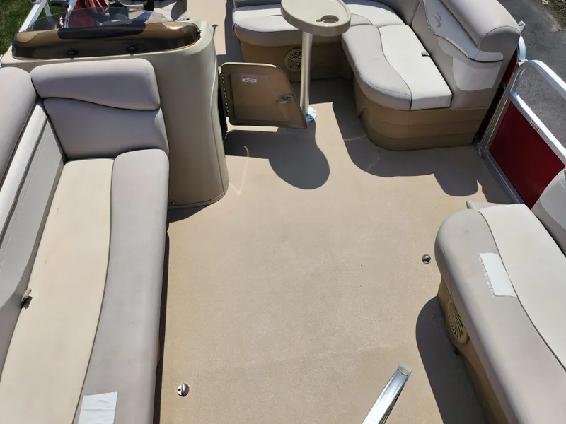 Slide: The Image of 2012 Bennington 22 SSL pontoon boat interior with beige seating and table. - 11