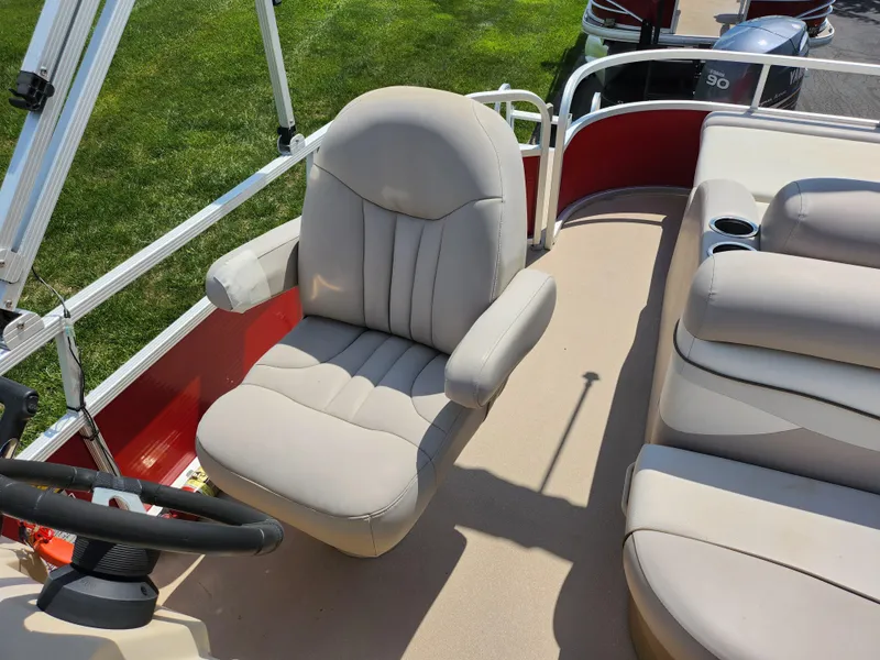 Slide: The Image of 2012 Bennington 22 SSL boat interior with beige seating and steering wheel. - 15