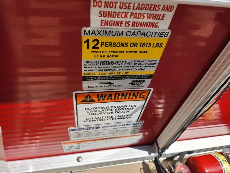 Slide: The Image of 2012 Bennington 22 SSL capacity and safety warning labels on red surface. - 16