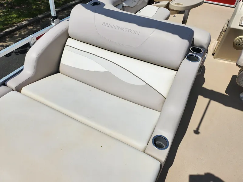 Slide: The Image of 2012 Bennington 22 SSL boat seating with cup holders, beige upholstery. - 20