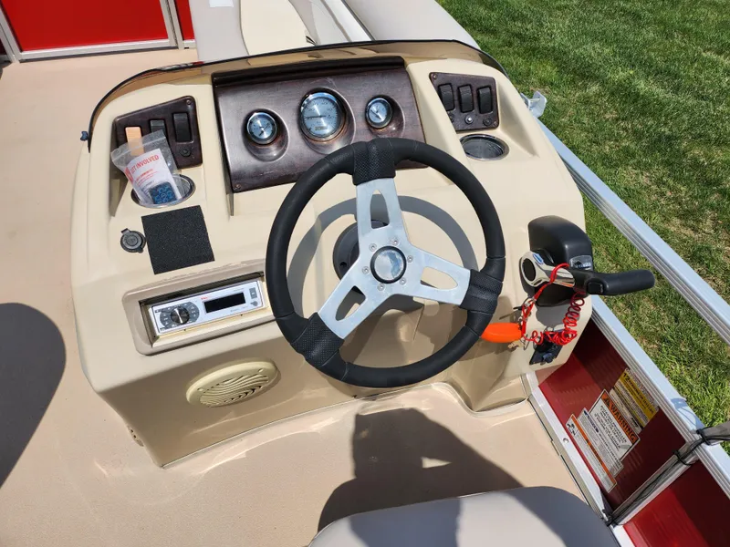 Slide: The Image of Steering console of a 2012 Bennington 22 SSL pontoon boat with gauges and controls. - 22