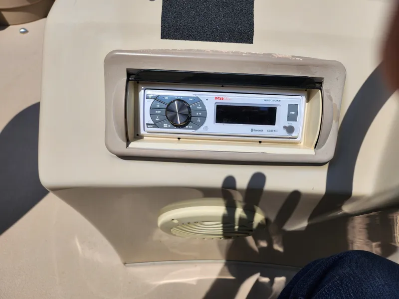 Slide: The Image of Boat stereo system on a 2012 Bennington 22 SSL, featuring a control panel and speaker. - 23