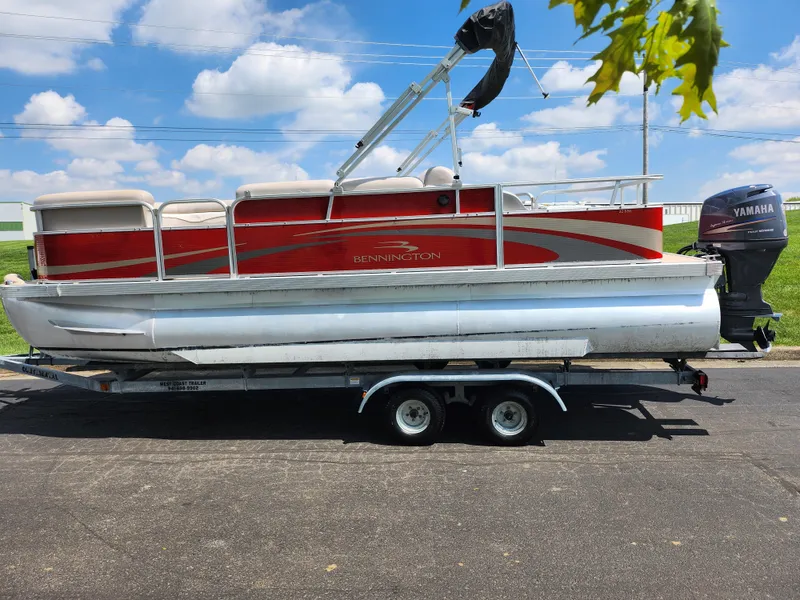 Slide: The Image of 2012 Bennington 22 SSL pontoon boat on trailer, red and silver design, Yamaha motor. - 4