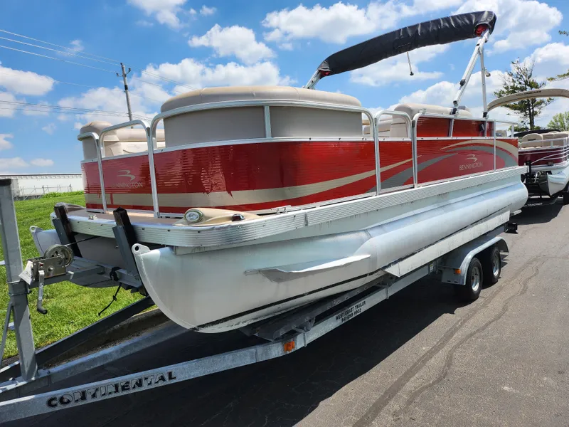 Slide: The Image of 2012 Bennington 22 SSL pontoon boat on trailer under a clear blue sky. - 5