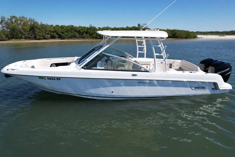 Slide: The Image of 2017 Boston Whaler 270 Vantage boat on calm water, side view. - 14
