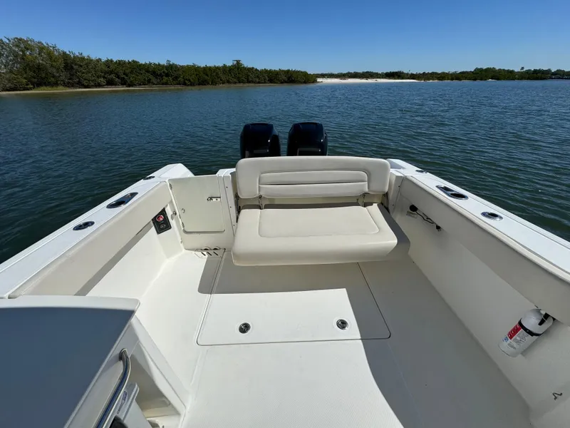 Slide: The Image of 2017 Boston Whaler 270 Vantage boat interior with seating, on calm water. - 20