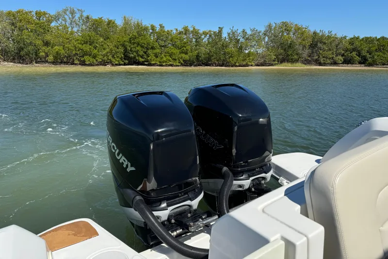 Slide: The Image of Twin Mercury outboard engines on a 2017 Boston Whaler 270 Vantage in calm waters. - 22