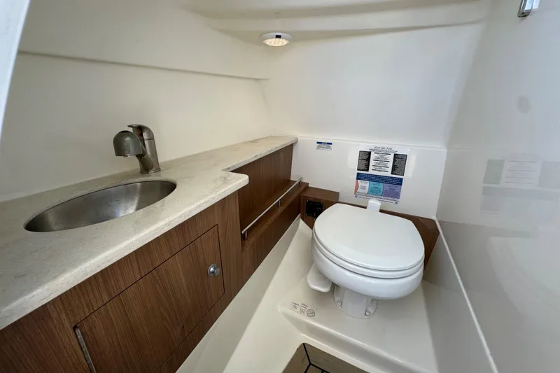 Slide: The Image of 2017 Boston Whaler 270 Vantage boat bathroom with sink and toilet. - 23