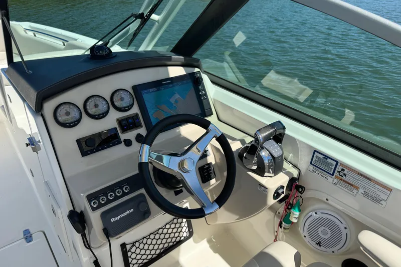 Slide: The Image of Cockpit of 2017 Boston Whaler 270 Vantage with navigation system and steering wheel. - 27