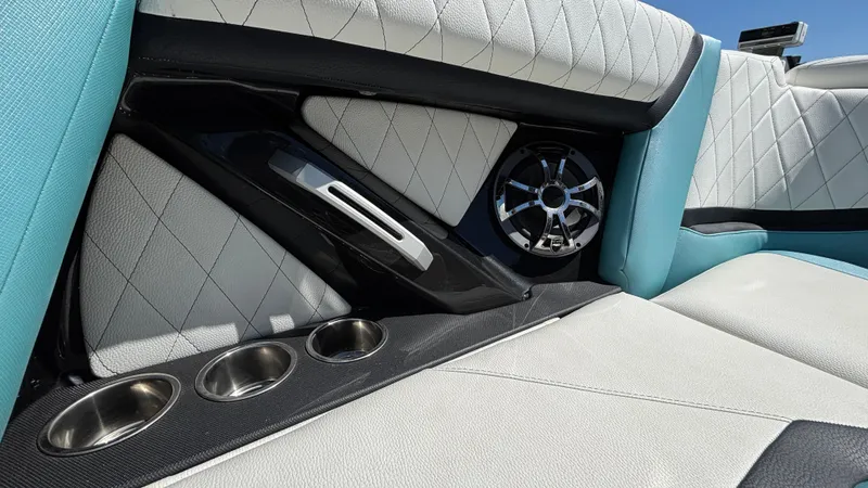 Slide: The Image of 2019 Tigé 25 ZXS interior with quilted seats, speaker, and cup holders. - 20