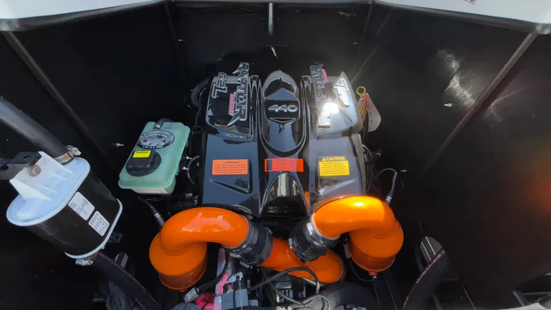 Slide: The Image of 2019 Tigé 25 ZXS engine compartment with vibrant orange air intakes. - 23