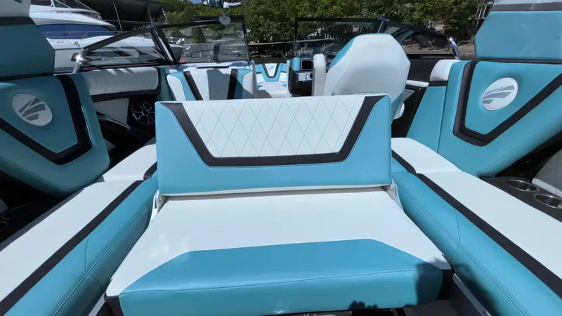 Slide: The Image of 2019 Tigé 25 ZXS boat interior with blue and white seating, featuring modern design elements. - 26