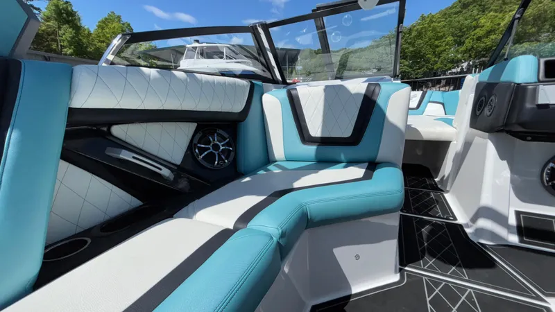 Slide: The Image of 2019 Tigé 25 ZXS boat interior with stylish blue and white seating. - 28