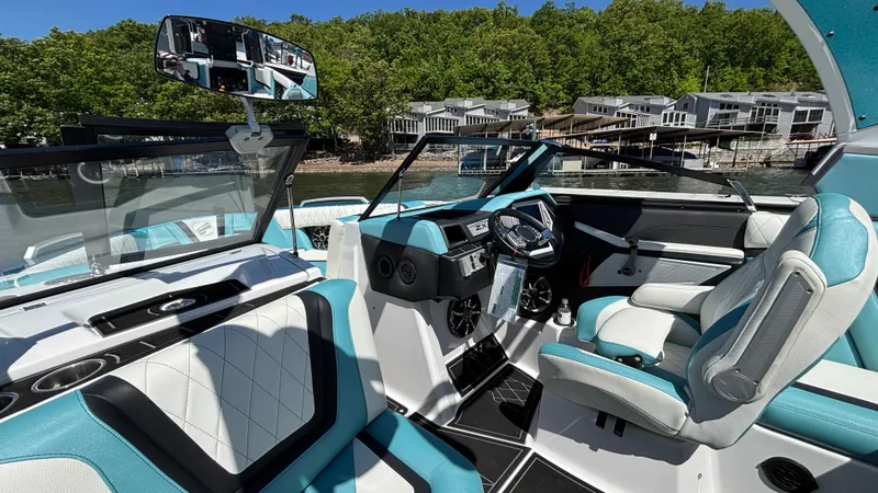 Slide: The Image of 2019 Tigé 25 ZXS boat interior with modern dashboard and turquoise seating. - 29