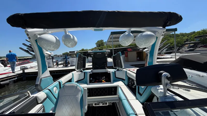 Slide: The Image of 2019 Tigé 25 ZXS boat interior with modern design and audio system at a marina. - 32