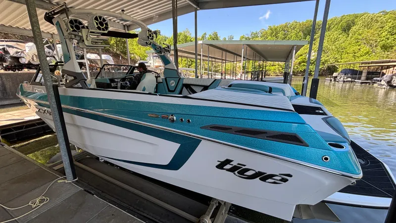 Slide: The Image of 2019 Tigé 25 ZXS boat docked, featuring sleek design and vibrant blue accents. - 35